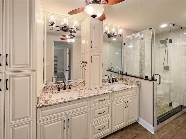 60 Chamale Cv Unit 60, Slidell, LA 70460 - bathroom with a ceiling fan, a shower stall, and double vanity