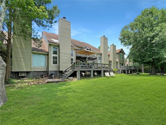 60 Chamale Cv Unit 60, Slidell, LA 70460 - back of property with a wooden deck, a lawn, stairway, and a chimney