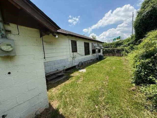 5013 Douglas Ave, Baton Rouge, LA 70805 - view of side of home with a lawn and a central AC unit