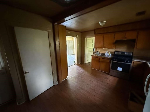 5013 Douglas Ave, Baton Rouge, LA 70805 - kitchen with stainless steel gas range, dark wood-style flooring, and brown cabinets