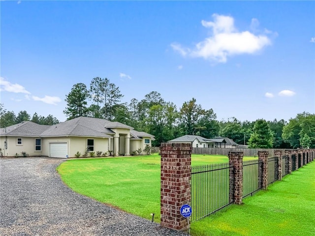 22484 Treadaway St, Mandeville, LA 70471 - view of property exterior featuring an attached garage, gravel driveway, and stucco siding