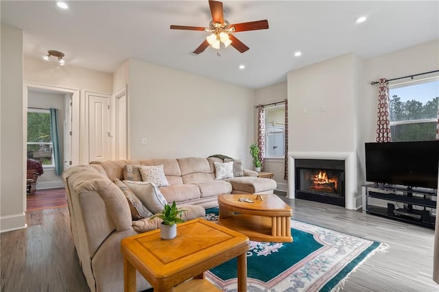 22484 Treadaway St, Mandeville, LA 70471 - living area featuring plenty of natural light, ceiling fan, a lit fireplace, wood finished floors, and recessed lighting