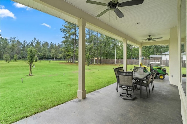 22484 Treadaway St, Mandeville, LA 70471 - fenced backyard with a ceiling fan, a patio, outdoor dining space, and view of scattered trees