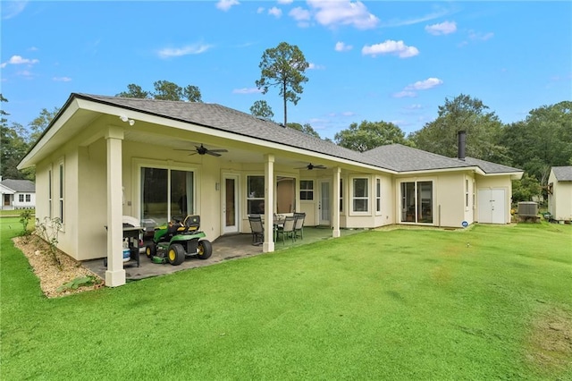 22484 Treadaway St, Mandeville, LA 70471 - back of property featuring a ceiling fan, a yard, a patio area, stucco siding, and roof with shingles