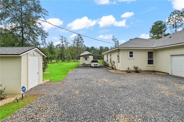 22484 Treadaway St, Mandeville, LA 70471 - view of property exterior featuring stucco siding, gravel driveway, a shingled roof, and a yard