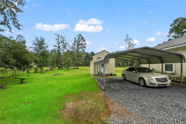 22484 Treadaway St, Mandeville, LA 70471 - view of grassy yard with a detached carport and gravel driveway