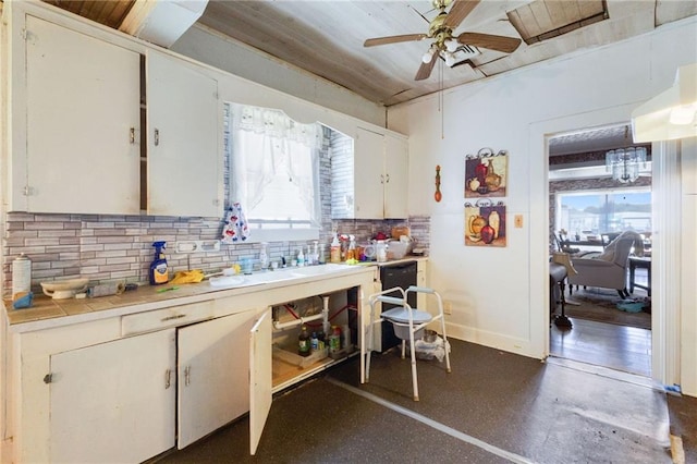 719 W Vine St, Opelousas, LA 70570 - kitchen with tile countertops, ceiling fan, tasteful backsplash, white cabinets, and dishwasher