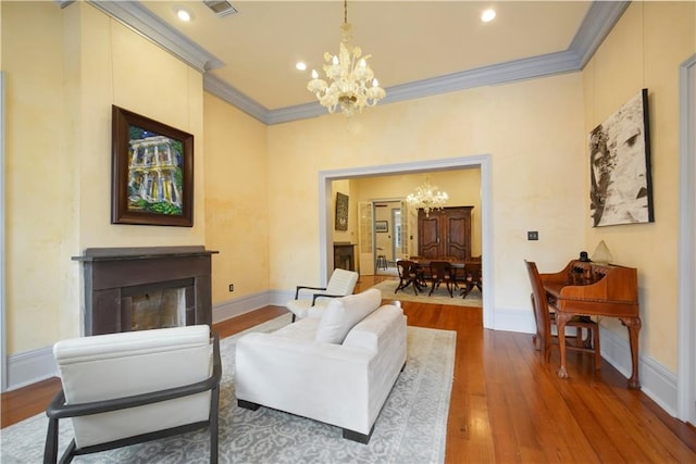 101921 Saint Peter St, New Orleans, LA 70116 - living room with a chandelier, ornamental molding, wood finished floors, a fireplace, and recessed lighting