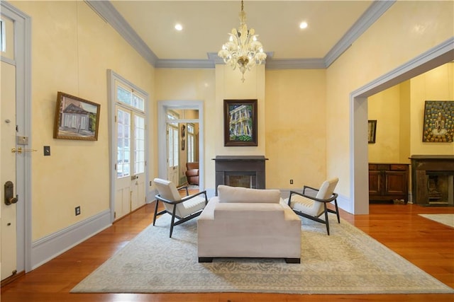 101921 Saint Peter St, New Orleans, LA 70116 - living area featuring a fireplace, wood finished floors, a chandelier, crown molding, and recessed lighting