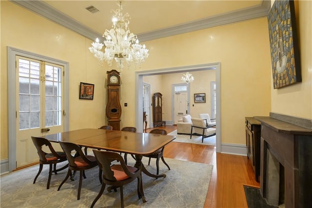 101921 Saint Peter St, New Orleans, LA 70116 - dining area with a chandelier, crown molding, and wood finished floors