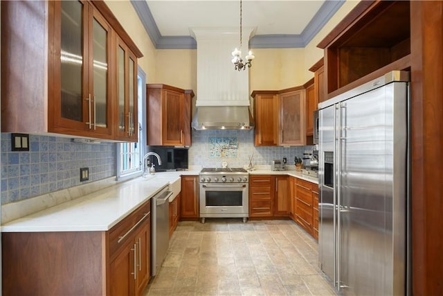 101921 Saint Peter St, New Orleans, LA 70116 - kitchen featuring high end appliances, ornamental molding, a chandelier, light countertops, and tasteful backsplash