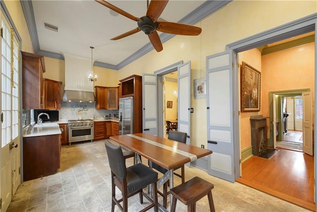 101921 Saint Peter St, New Orleans, LA 70116 - kitchen featuring high quality appliances, light countertops, backsplash, ceiling fan, and crown molding