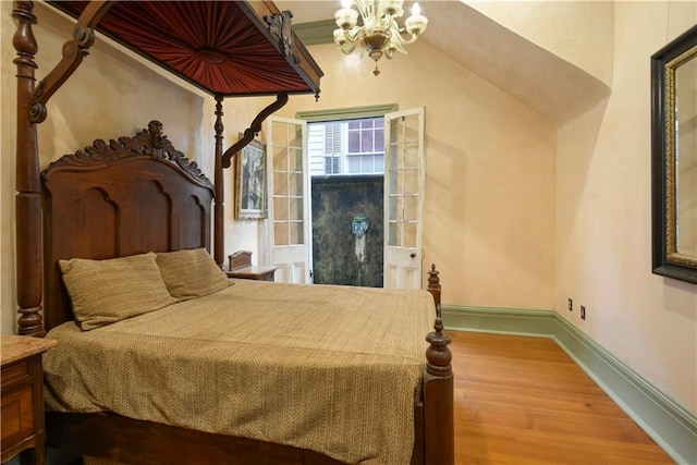 101921 Saint Peter St, New Orleans, LA 70116 - bedroom with wood finished floors and a chandelier