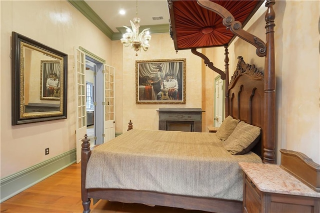 101921 Saint Peter St, New Orleans, LA 70116 - bedroom with wood finished floors, crown molding, and a chandelier