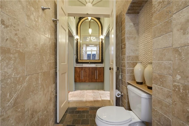 101921 Saint Peter St, New Orleans, LA 70116 - bathroom featuring tile walls, stone tile floors, and vanity