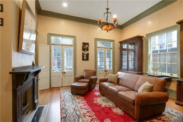 101921 Saint Peter St, New Orleans, LA 70116 - living area featuring ornamental molding, wood finished floors, a chandelier, a fireplace with flush hearth, and recessed lighting