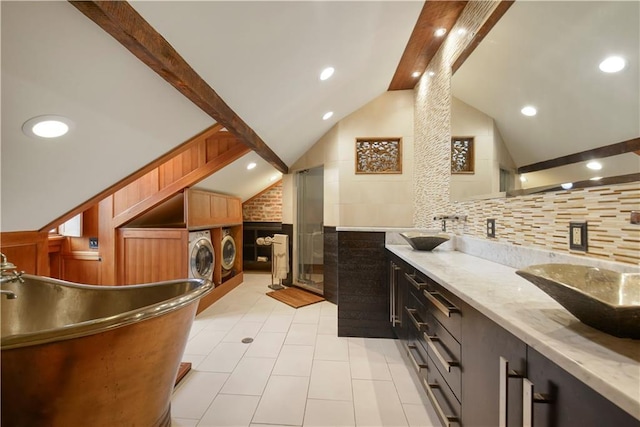 101921 Saint Peter St, New Orleans, LA 70116 - kitchen featuring separate washer and dryer, a wainscoted wall, light tile patterned floors, recessed lighting, and light stone counters