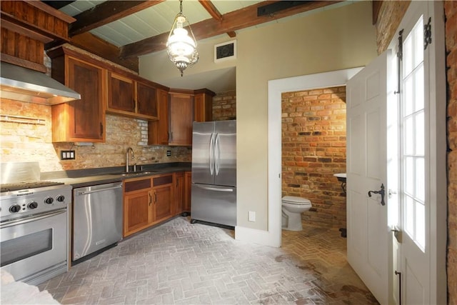 101921 Saint Peter St, New Orleans, LA 70116 - kitchen featuring appliances with stainless steel finishes, decorative backsplash, brick floors, beamed ceiling, and brown cabinets