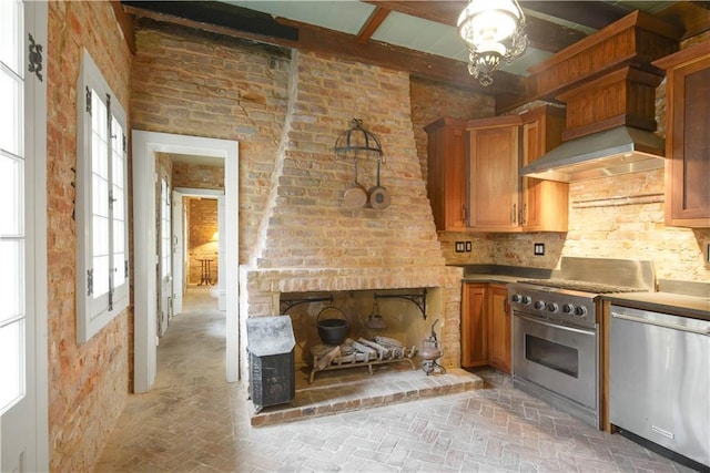 101921 Saint Peter St, New Orleans, LA 70116 - kitchen featuring appliances with stainless steel finishes, brick floors, brown cabinetry, and beamed ceiling