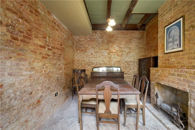 101921 Saint Peter St, New Orleans, LA 70116 - dining area featuring brick flooring, beamed ceiling, and brick wall
