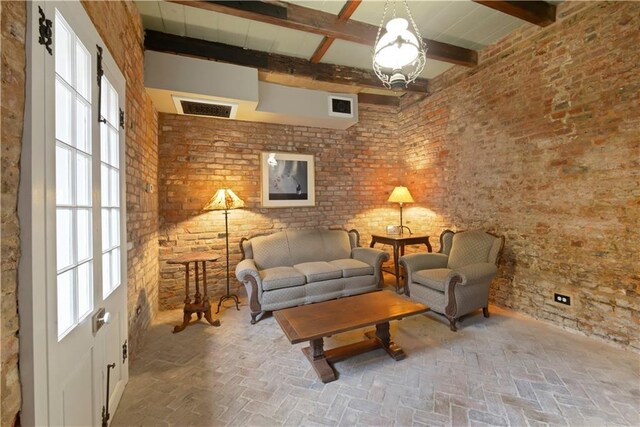 101921 Saint Peter St, New Orleans, LA 70116 - living area with beam ceiling, brick floors, and plenty of natural light