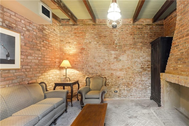 101921 Saint Peter St, New Orleans, LA 70116 - sitting room with beamed ceiling, a fireplace, brick patterned flooring, a chandelier, and brick wall