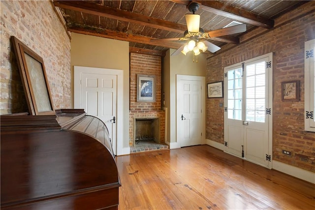101921 Saint Peter St, New Orleans, LA 70116 - entryway featuring hardwood / wood-style flooring, a wooden ceiling with exposed beams, ceiling fan, a brick fireplace, and brick wall