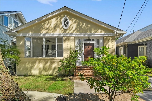 1316 Lowerline St, New Orleans, LA 70118 - view of front facade with brick siding, ceiling fan, and a front yard