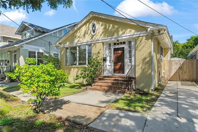 1316 Lowerline St, New Orleans, LA 70118 - view of front of property featuring brick siding, entry steps, and a gate