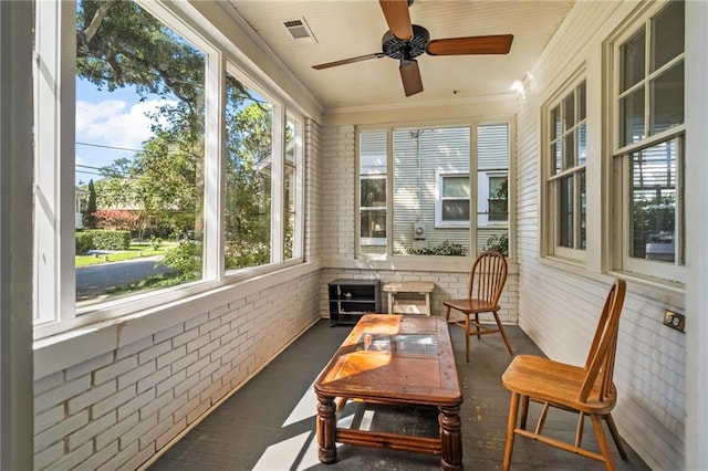 1316 Lowerline St, New Orleans, LA 70118 - sunroom / solarium featuring brick wall, ceiling fan, crown molding, and finished concrete floors