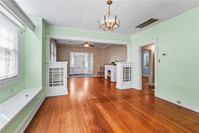 1316 Lowerline St, New Orleans, LA 70118 - unfurnished living room featuring a chandelier, hardwood / wood-style flooring, ornamental molding, and ceiling fan
