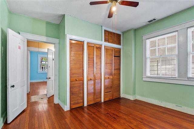1316 Lowerline St, New Orleans, LA 70118 - unfurnished bedroom featuring multiple closets, wood-type flooring, and a ceiling fan