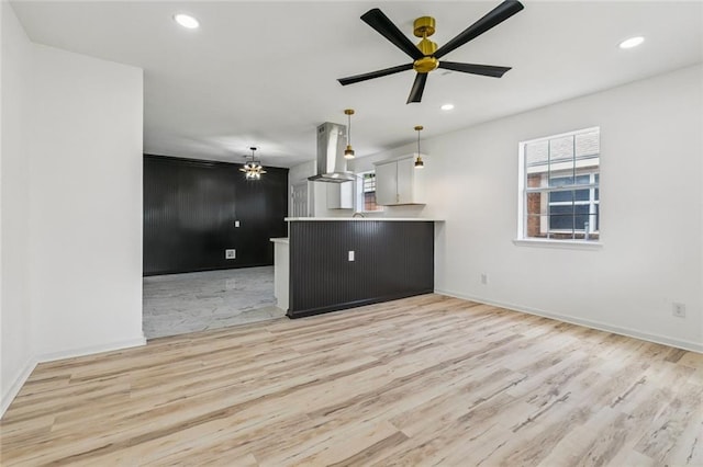 1621 Congress St, New Orleans, LA 70117 - unfurnished living room with light wood-style floors, ceiling fan, recessed lighting, and a chandelier