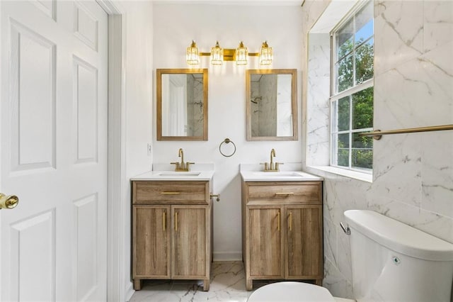 1621 Congress St, New Orleans, LA 70117 - bathroom featuring two vanities and marble finish flooring