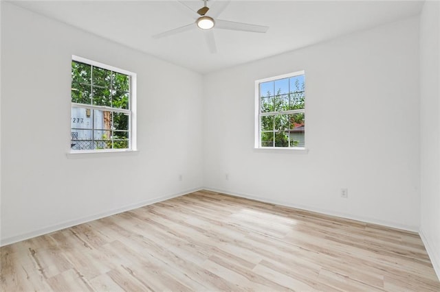 1621 Congress St, New Orleans, LA 70117 - empty room featuring plenty of natural light, wood finished floors, and a ceiling fan