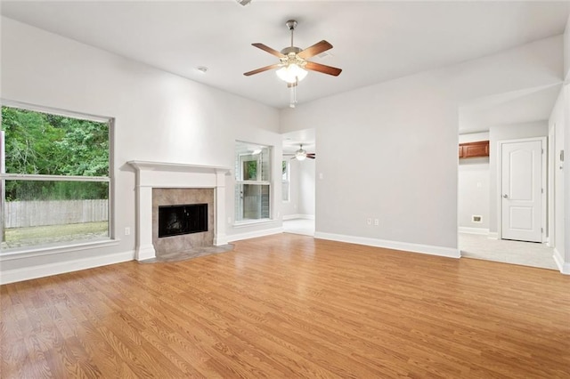 41151 Snowball Cir, Ponchatoula, LA 70454 - unfurnished living room with a ceiling fan, light wood finished floors, and a tiled fireplace