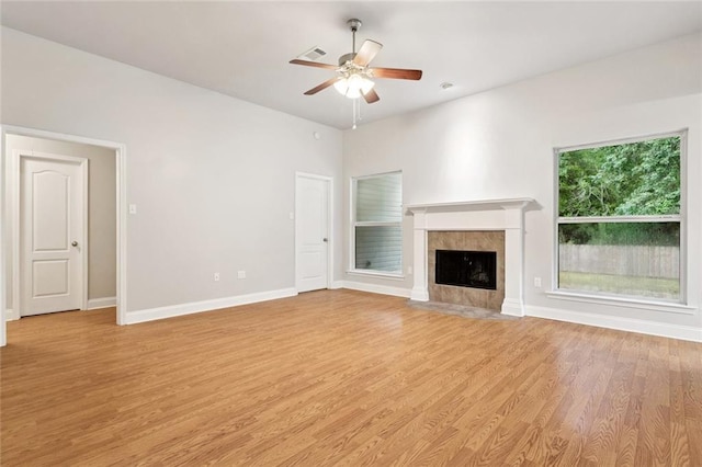 41151 Snowball Cir, Ponchatoula, LA 70454 - unfurnished living room featuring ceiling fan, light wood finished floors, and a tiled fireplace