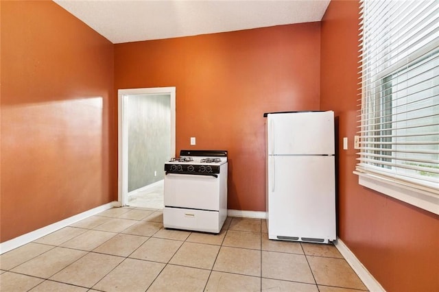264951 Bruxelles St, New Orleans, LA 70119 - kitchen featuring white appliances and light tile patterned floors