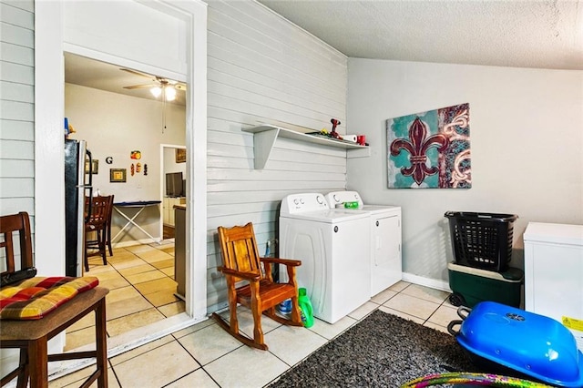 264951 Bruxelles St, New Orleans, LA 70119 - laundry room featuring washer and clothes dryer, wooden walls, light tile patterned flooring, a ceiling fan, and a textured ceiling