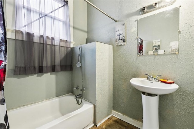 264951 Bruxelles St, New Orleans, LA 70119 - bathroom with a textured wall and washtub / shower combination