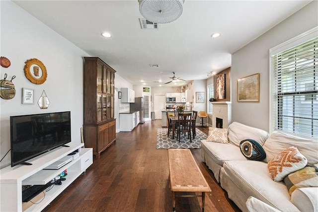 4472 Demontluzin St, New Orleans, LA 70122 - living area with a brick fireplace, dark wood-type flooring, ceiling fan, and recessed lighting