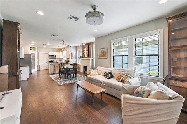 4472 Demontluzin St, New Orleans, LA 70122 - living area featuring recessed lighting, dark wood-style floors, ceiling fan, and a fireplace
