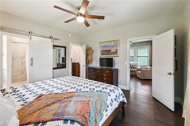4472 Demontluzin St, New Orleans, LA 70122 - bedroom with dark wood finished floors, a barn door, ceiling fan, and ensuite bathroom