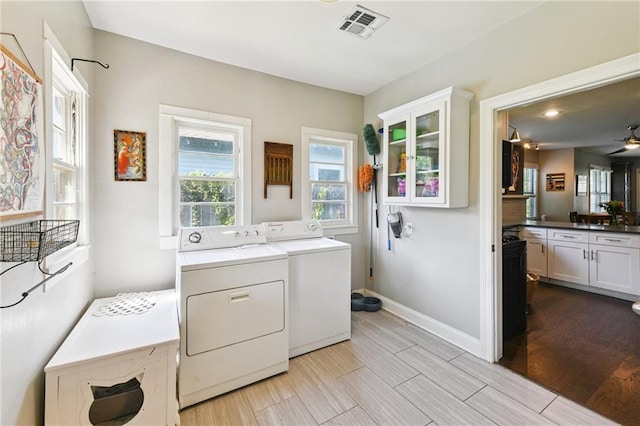 4472 Demontluzin St, New Orleans, LA 70122 - laundry room featuring washer and dryer, wood finished floors, and ceiling fan