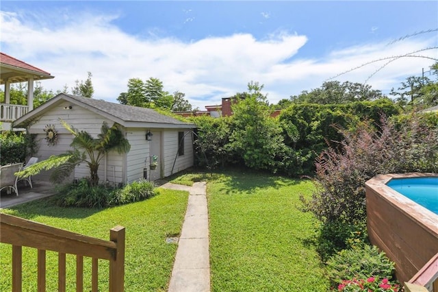 4472 Demontluzin St, New Orleans, LA 70122 - view of green lawn featuring an outdoor structure