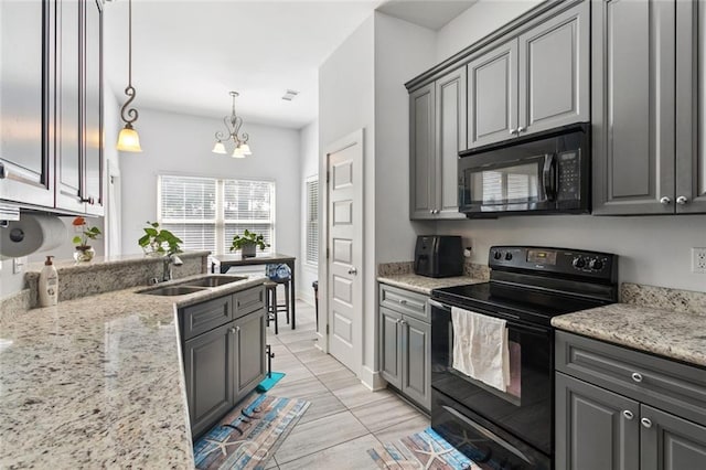 1383 Cherry St, Slidell, LA 70460 - kitchen featuring black appliances, gray cabinets, a chandelier, light stone countertops, and pendant lighting