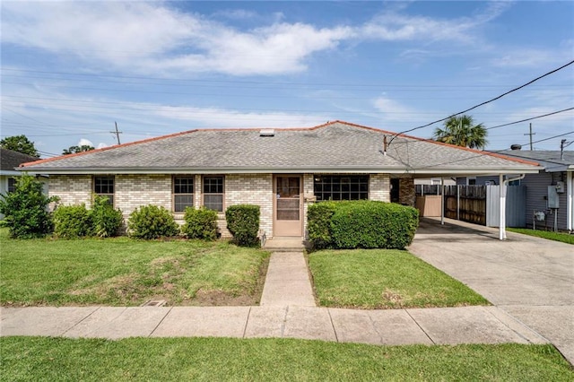 15 Tulip Dr, Gretna, LA 70053 - single story home featuring driveway, a carport, a shingled roof, and brick siding