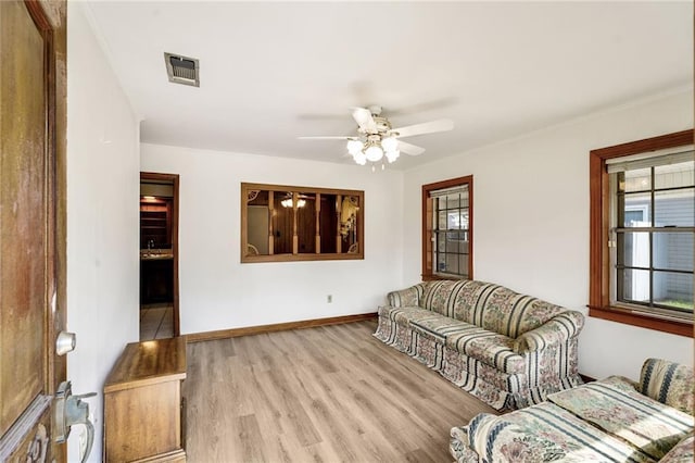 15 Tulip Dr, Gretna, LA 70053 - living room featuring wood finished floors, ceiling fan, and ornamental molding