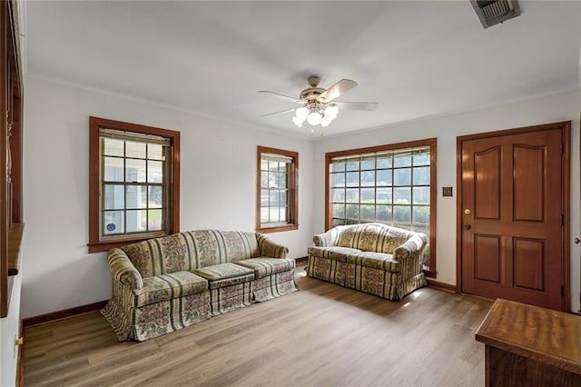 15 Tulip Dr, Gretna, LA 70053 - living room with wood finished floors, a ceiling fan, and crown molding