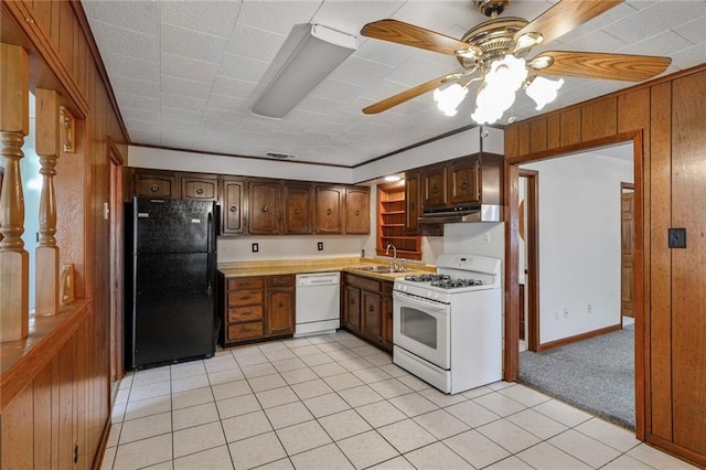 15 Tulip Dr, Gretna, LA 70053 - kitchen with white appliances, under cabinet range hood, ceiling fan, light tile patterned floors, and light countertops